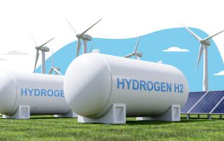 Hydrogen tanks in a field with wind turbines