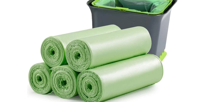 rolls-of-green-compostable-trash-bags-against-a-white-background