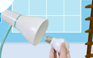 person-changing-a-light-bulb-in-their-home