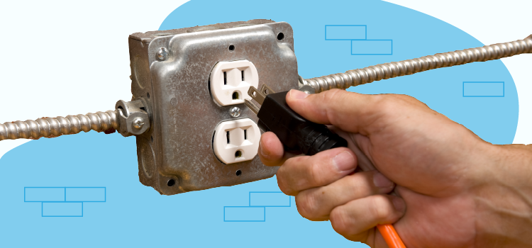 person plugging a cord in an outlet