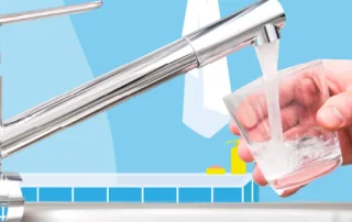man filling up a cup in a bathroom
