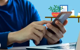 man-on-phone-next-to-a-computer-in-living-room
