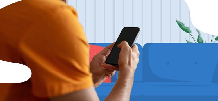 person-looking-at-their-phone-in-their-living-room