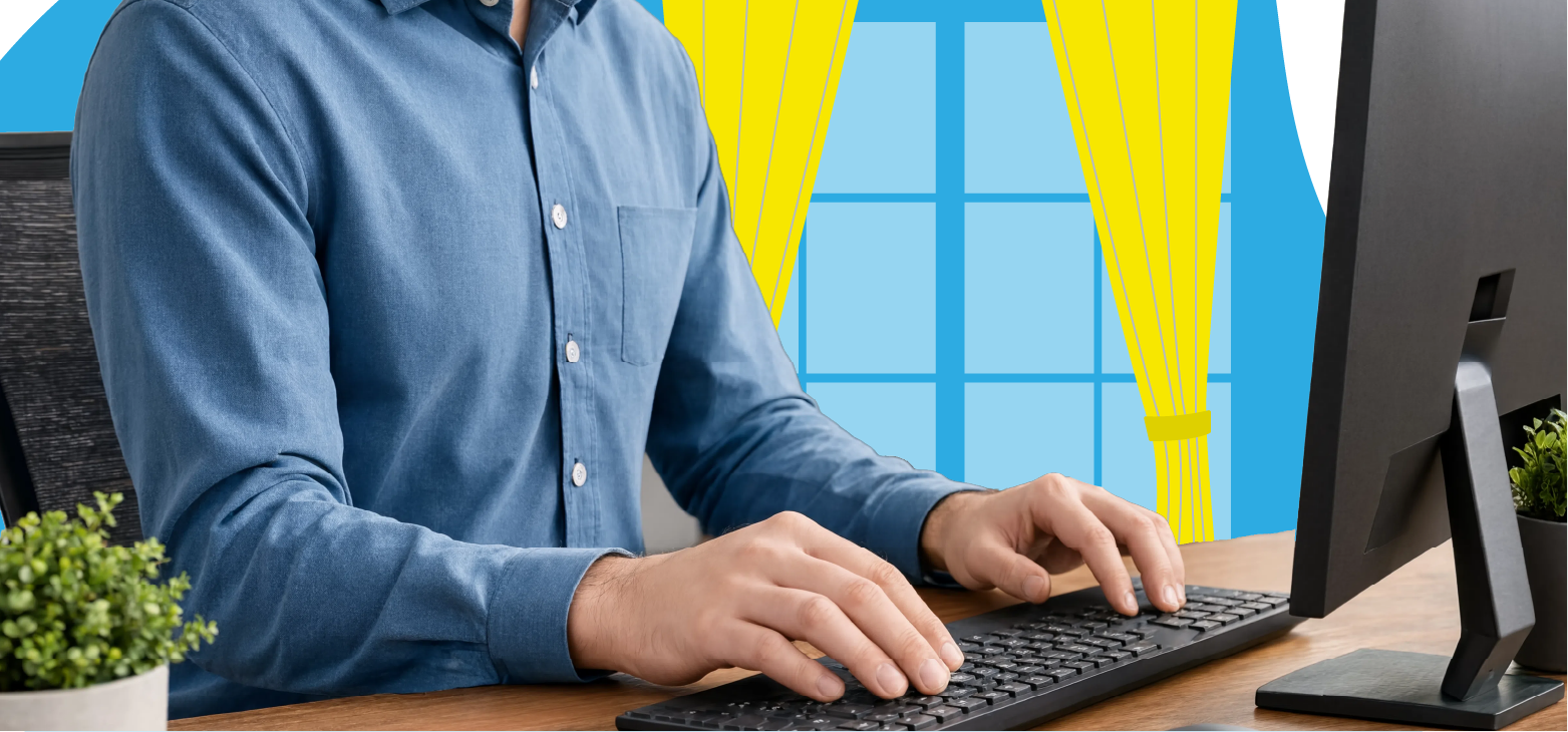 Person-working-at-a-desktop-computer-in-a-home-office-with-a-bright-window-in-the-background